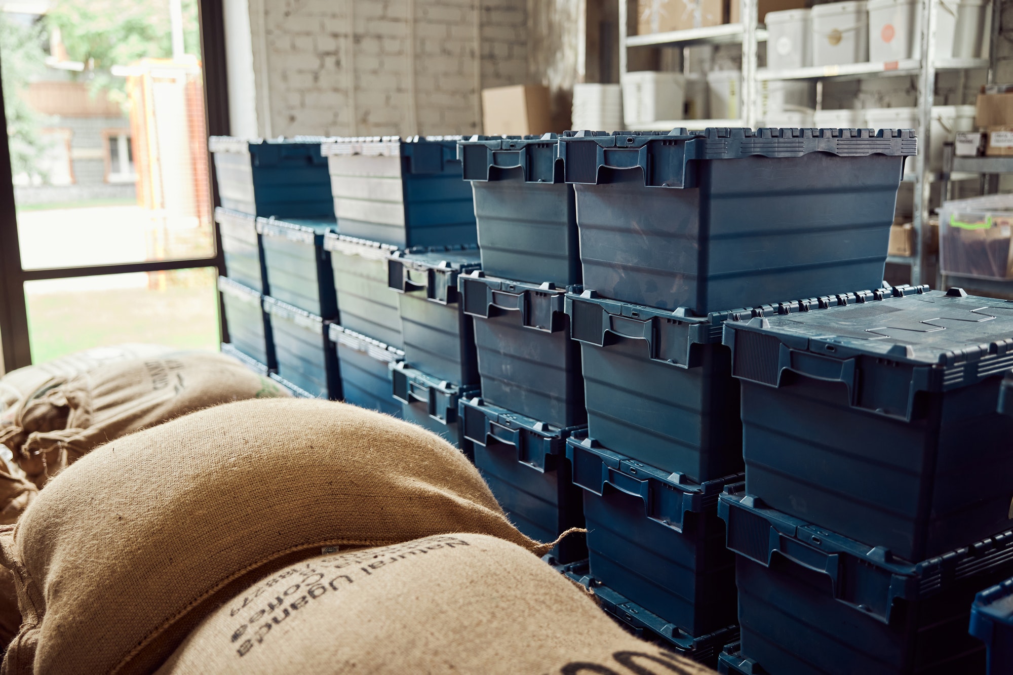 lidded storage crates and bags with coffee beans - Stockage